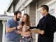 couple signing papers fr new house